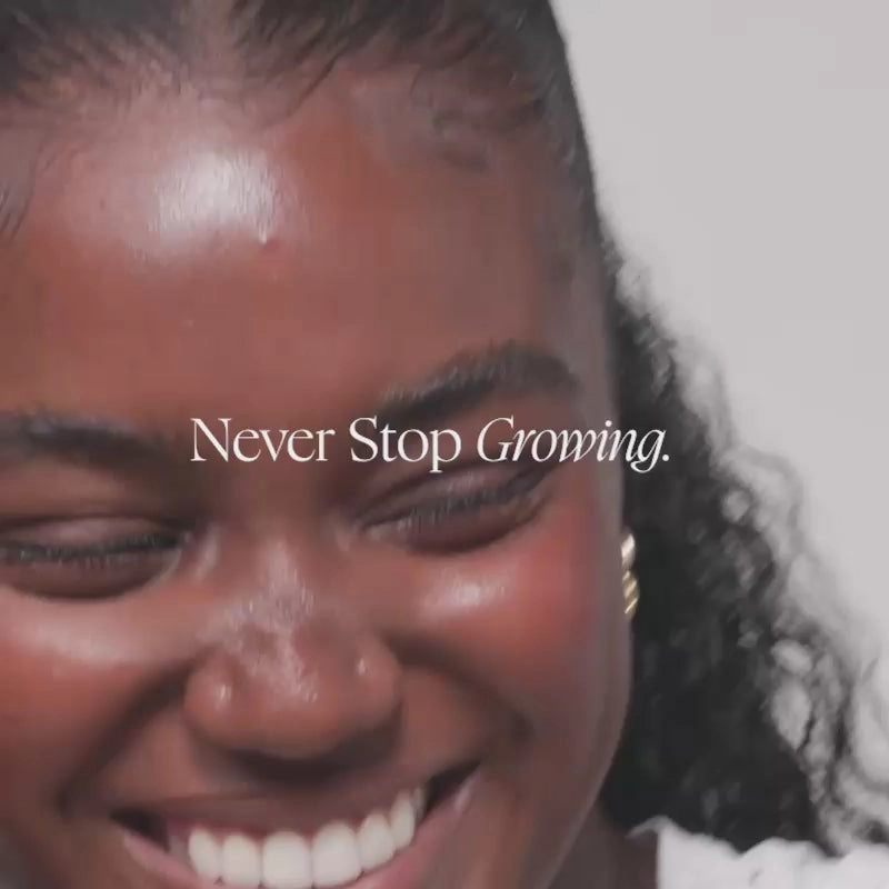 Smiling woman with the words Never Stop Growing over the photo